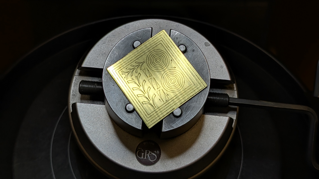 A square brass plate with scroll designs for hand engraving