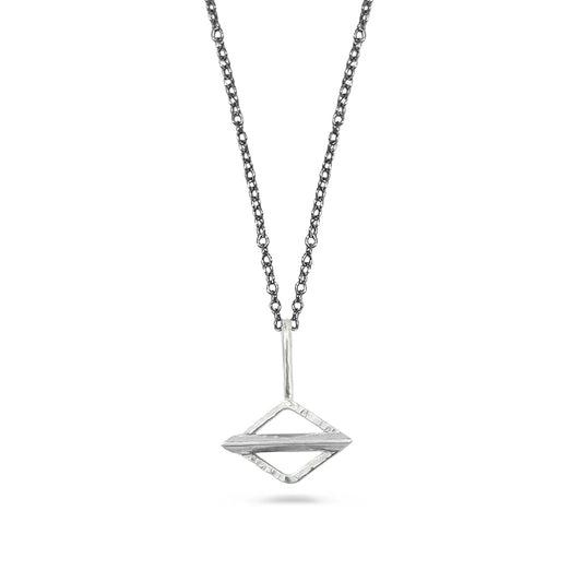 Silver geometric pendant necklace on a white background
