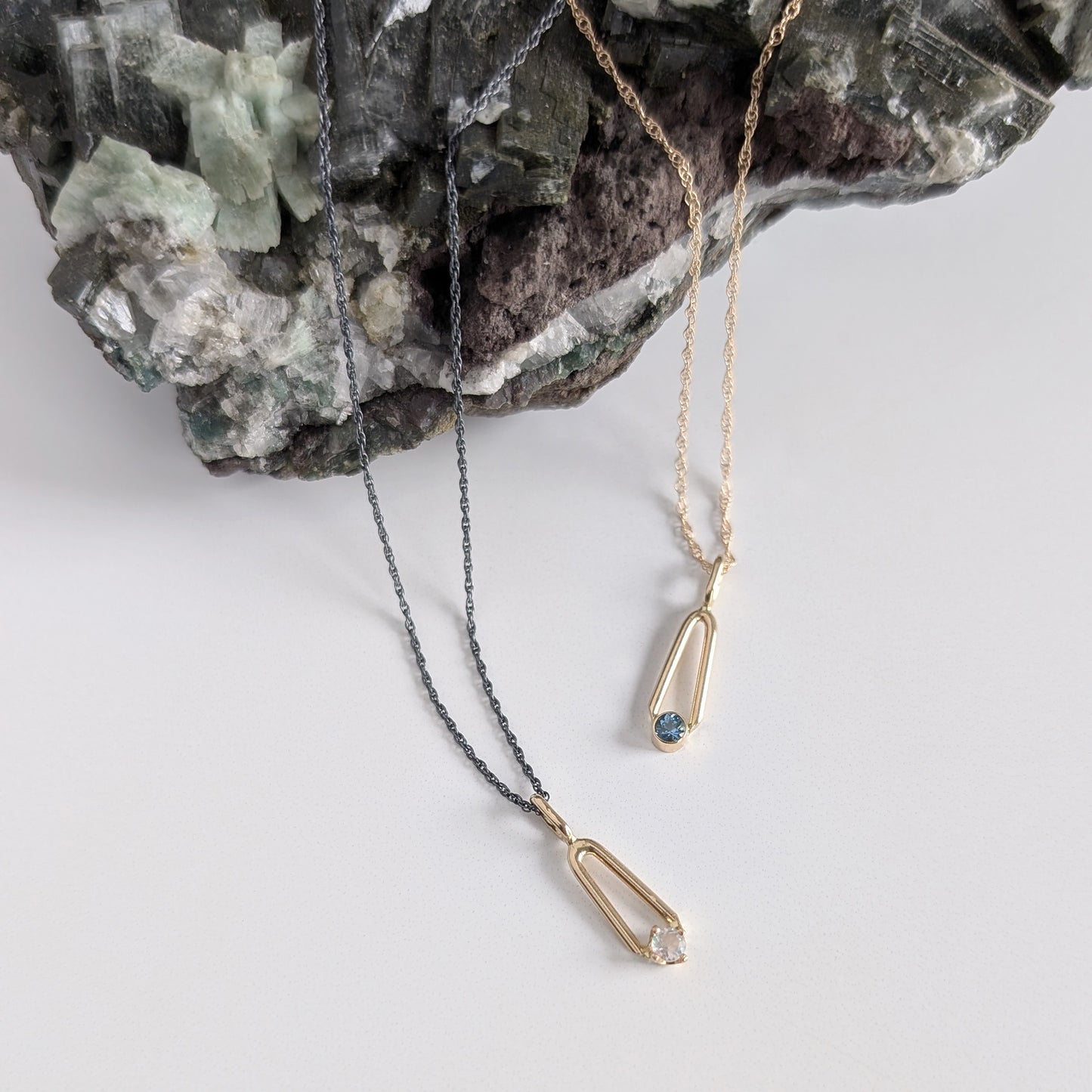 14K Gold Sapphire and moonstone teardrop charm pendants on charcoal and gold chains