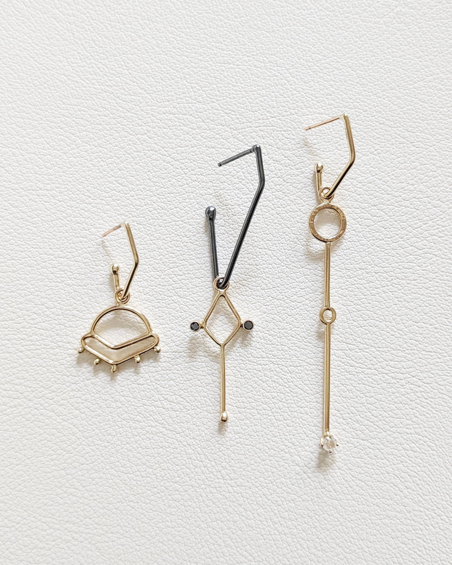 gold and silver charms on charm hoop earrings