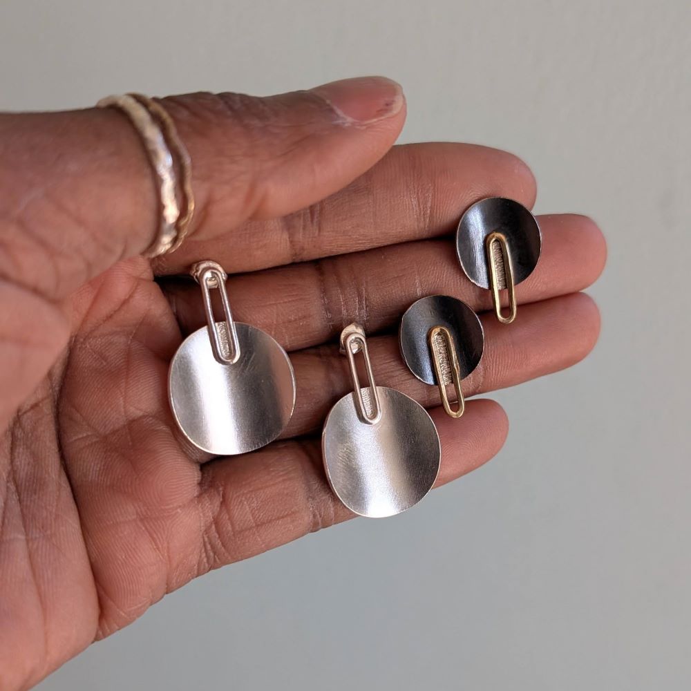 Silver and charcoal disk studs with long 14k gold oval
