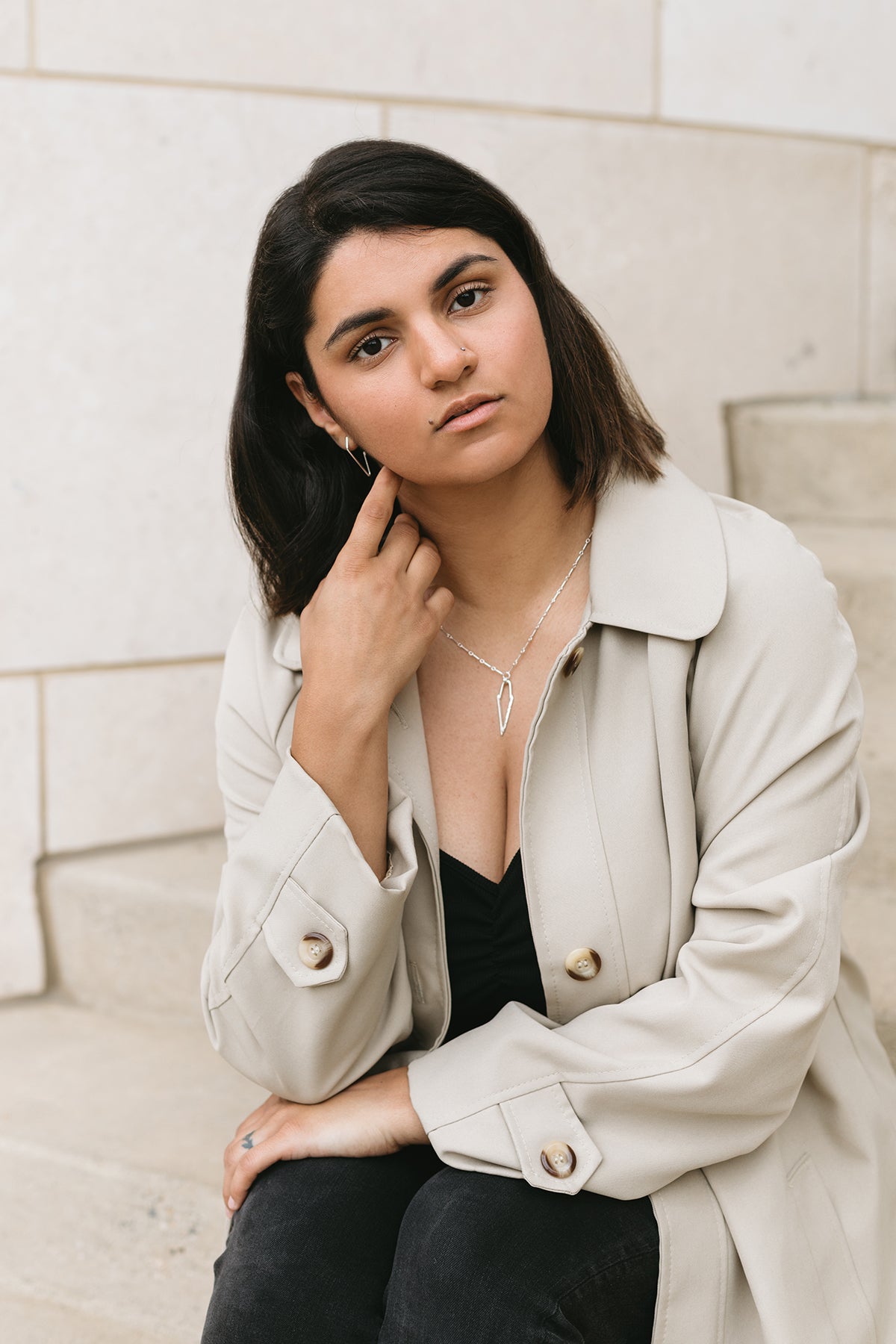 Silver dagger necklace on model