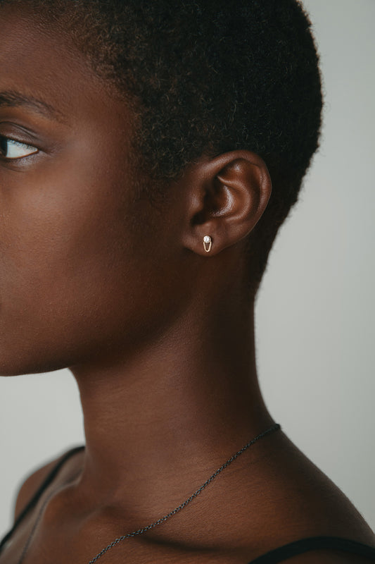 diamond gold stud earrings worn on model