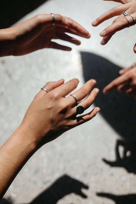 various hammered stacking rings in silver styled on model