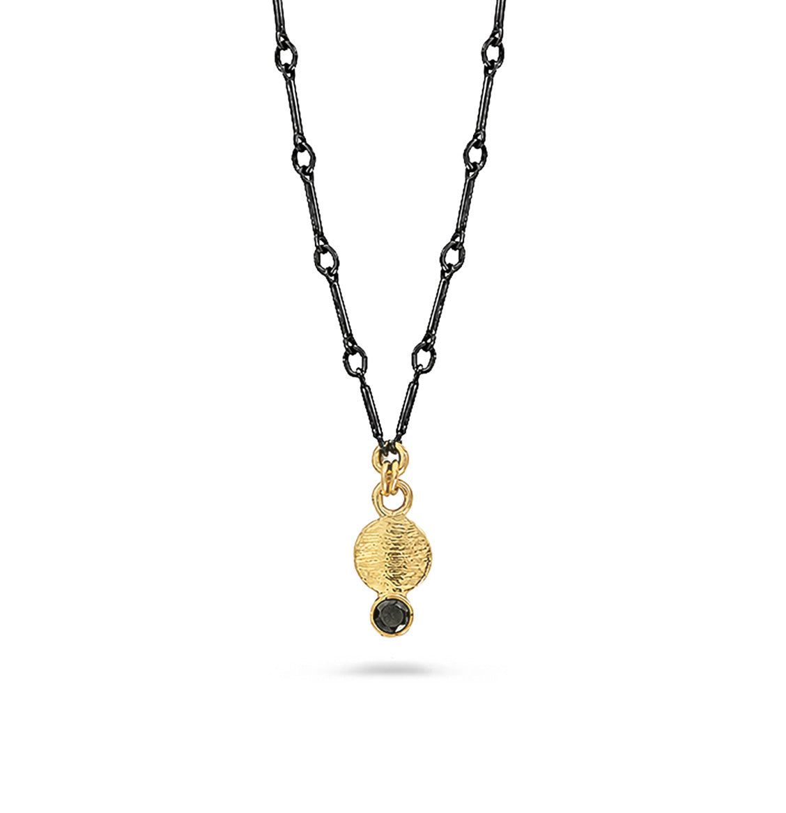 A gold pendant necklace and black diamond suspended on a black chain against a white background.