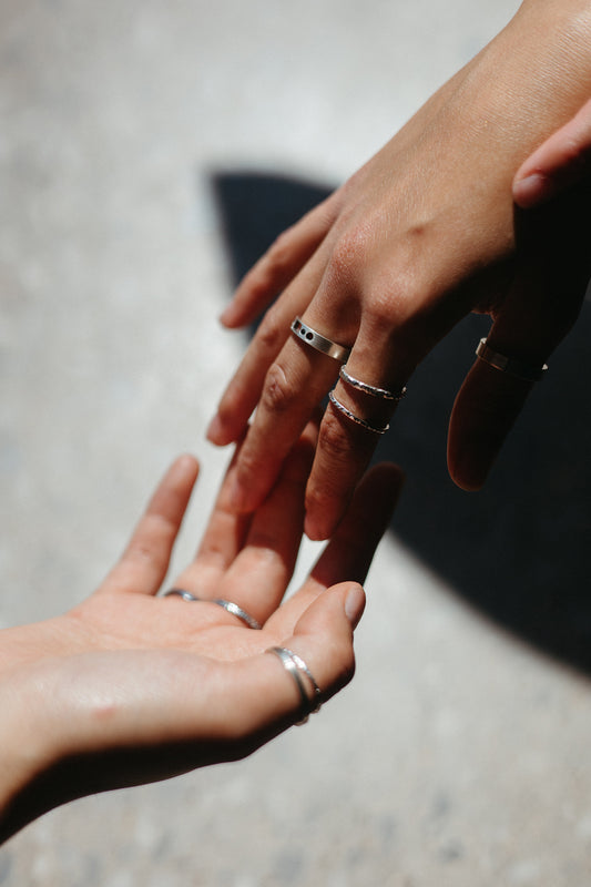 textured Silver stacking rings styled on model