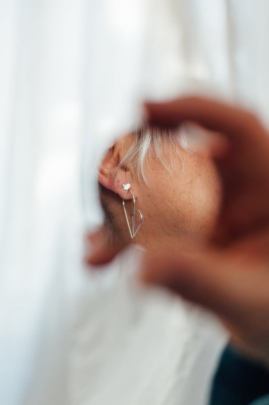 Heart studs and threader hoop earrings in sterling silver on model