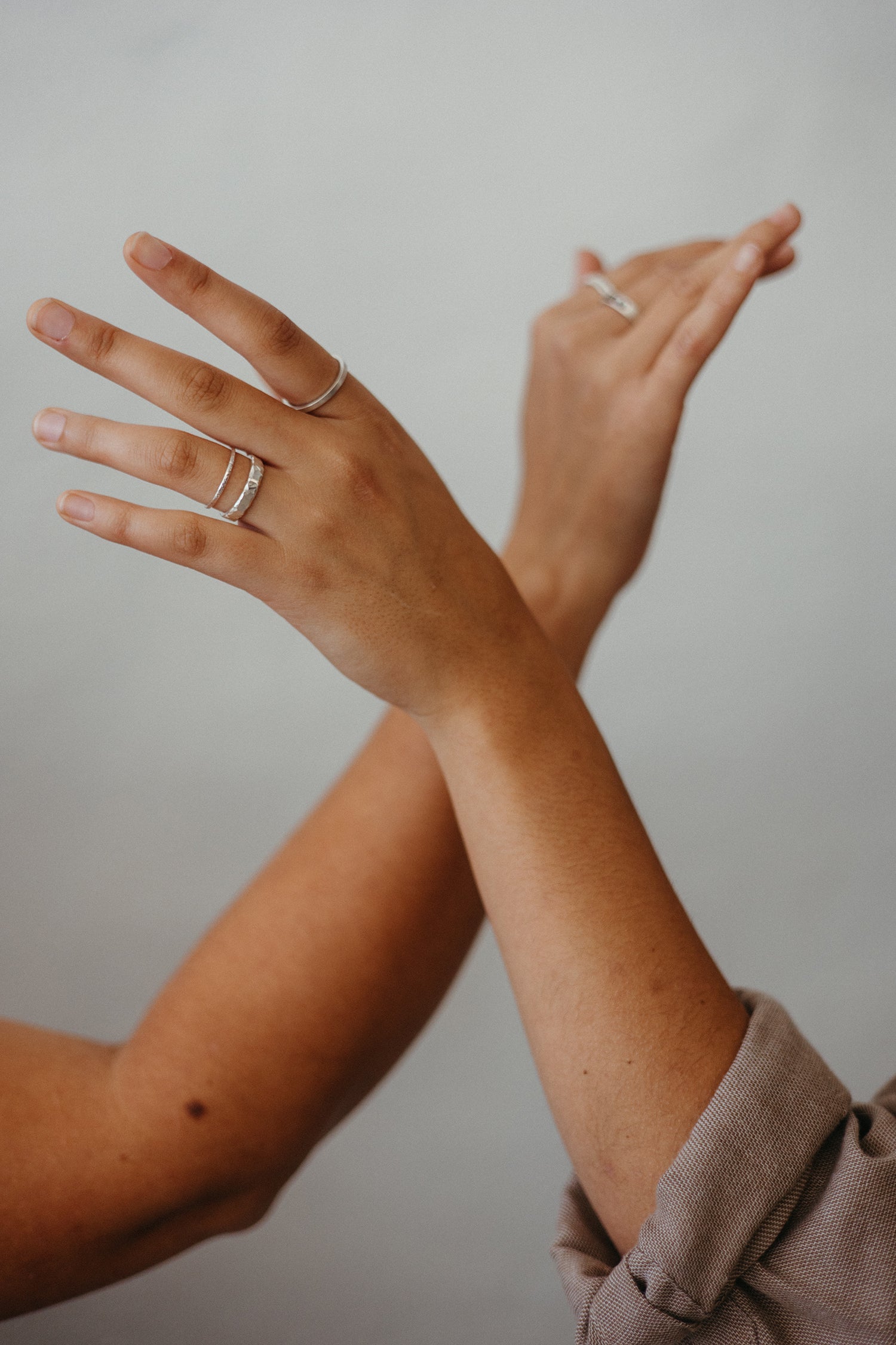 silver textured stacking ring bands on model