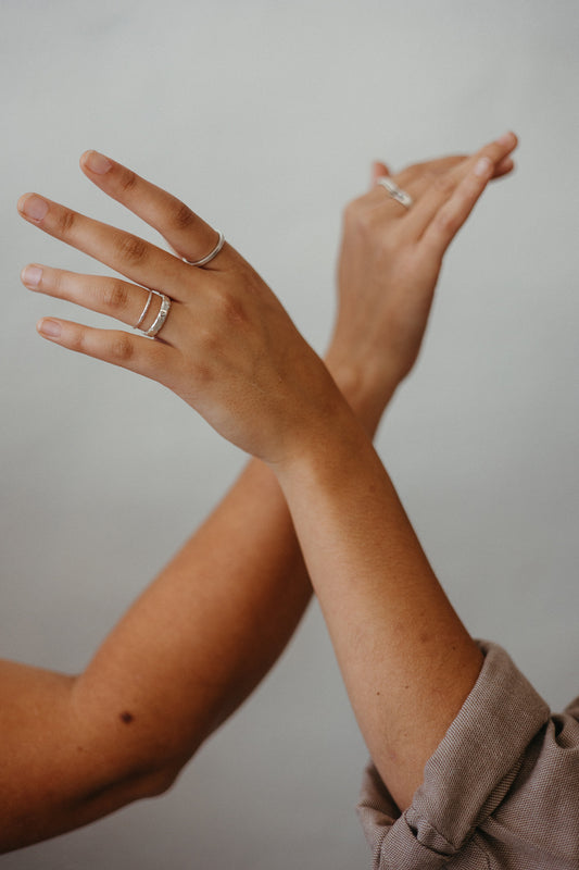 silver textured stacking ring bands on model