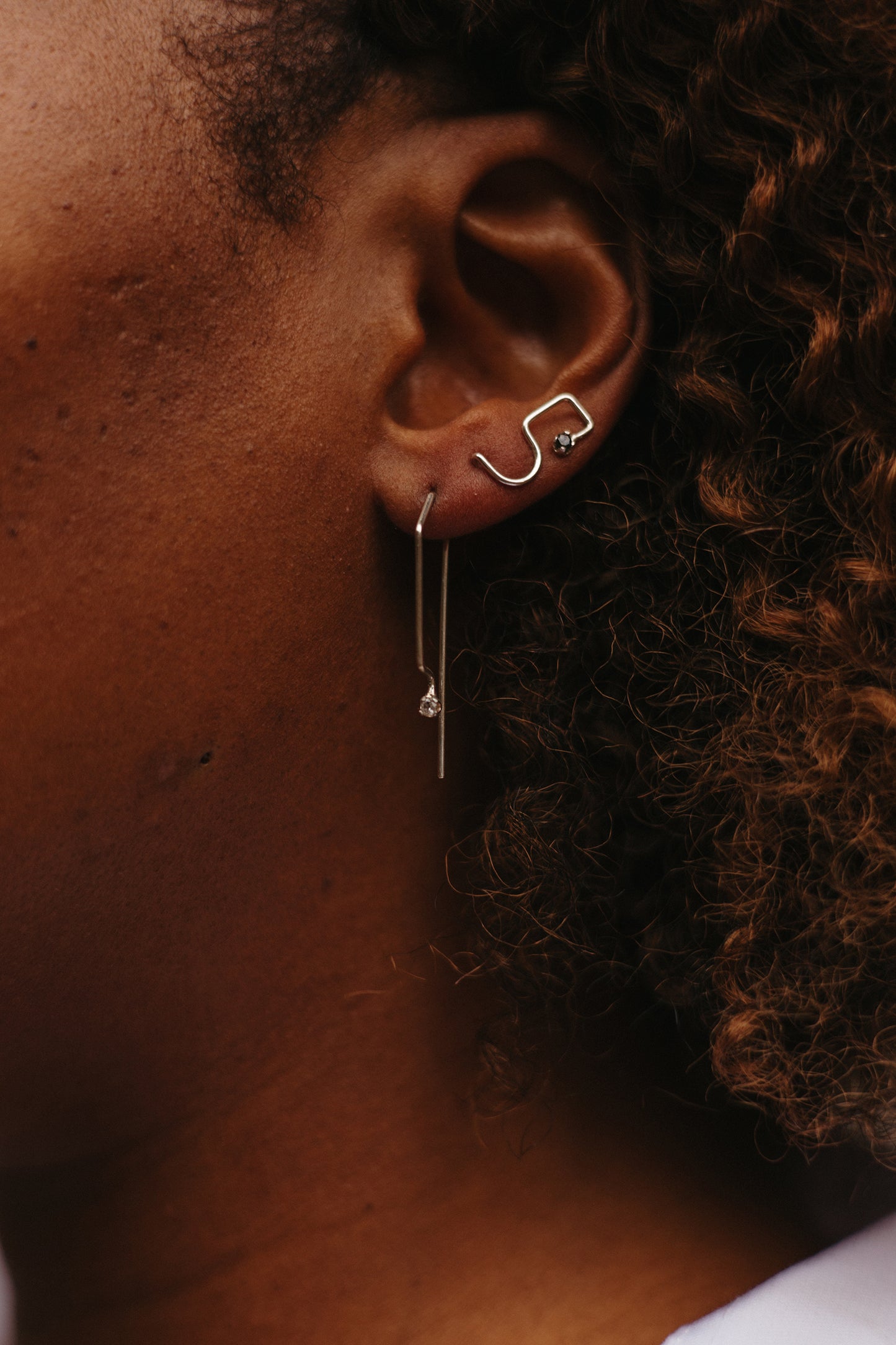 Ear climber earrings with black diamonds in sterling silver styled on model