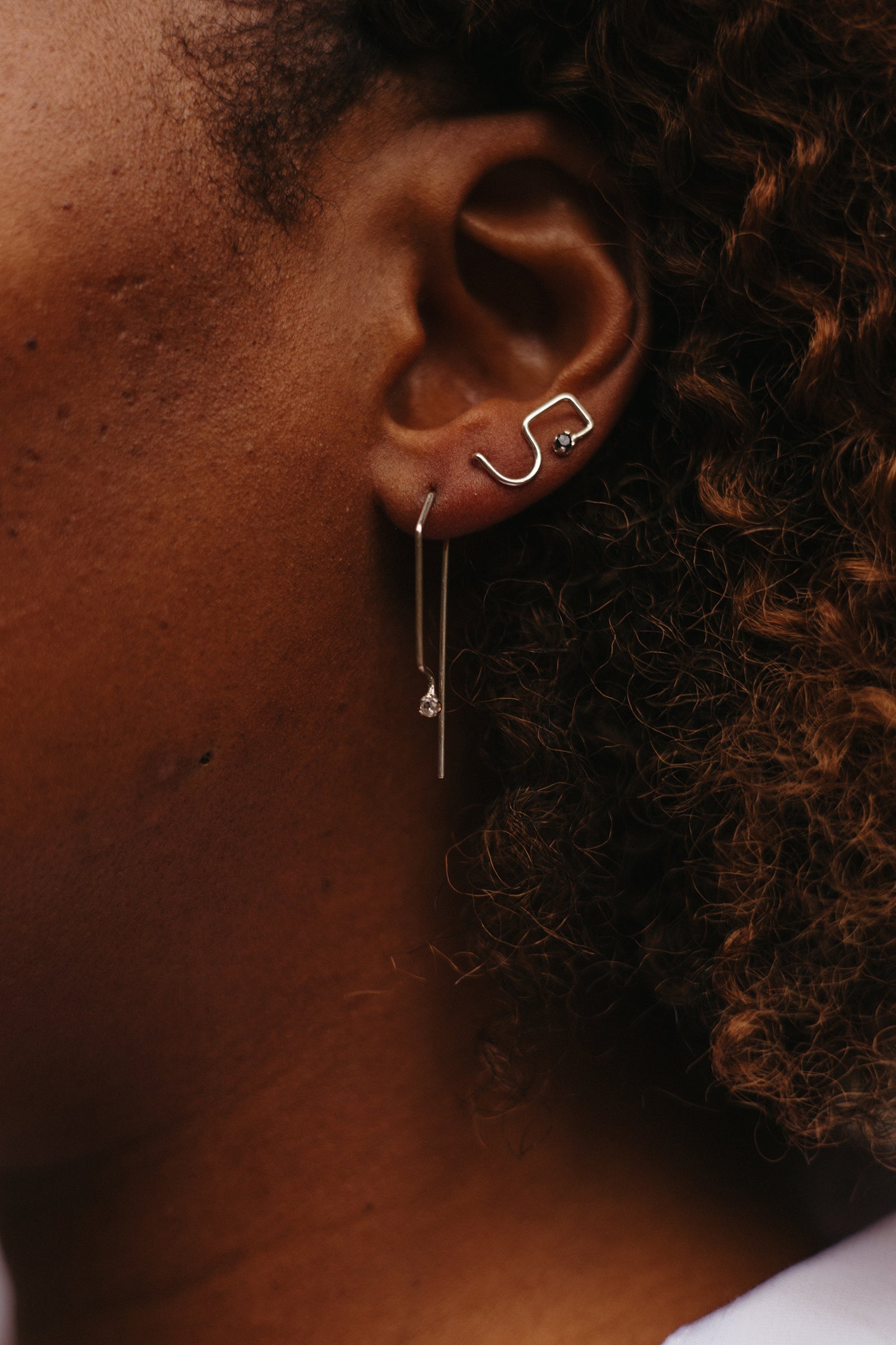 Ear climber earrings with black diamonds in sterling silver styled on model