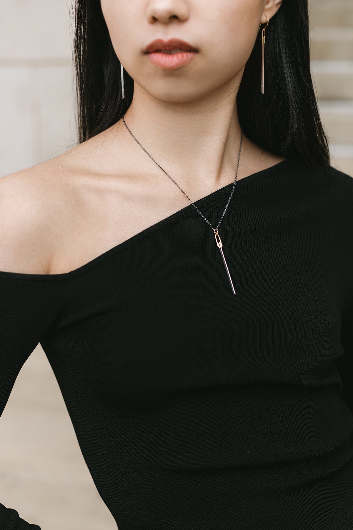 silver and gold knife-edge bar pendant necklace styled with matching earrings on model
