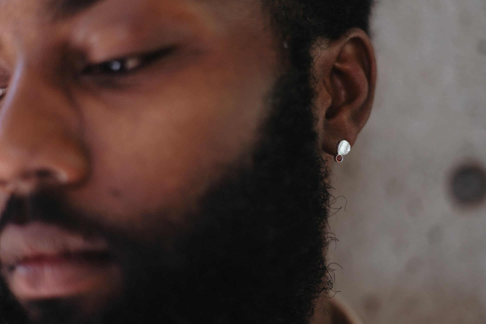 Small silver textured disk studs styled on model