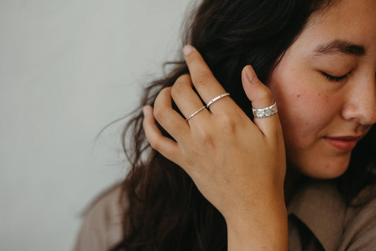 model wearing linen textured dotted silver stacking ring