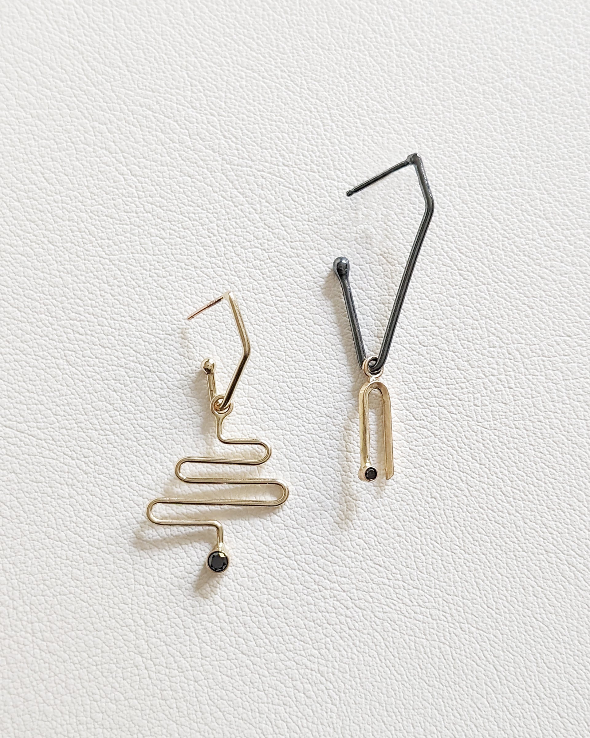 14K yellow gold arch charm and three-tiered zigzag charm with black diamond on charm hoops
