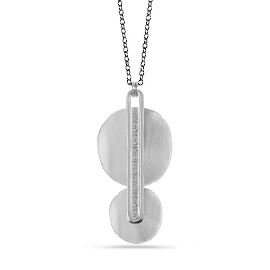 two stacked silver disks with elongated oval pendant necklace on charcoal chain