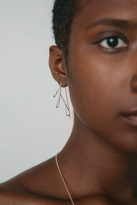 model wearing floral threader hoop earrings in silver