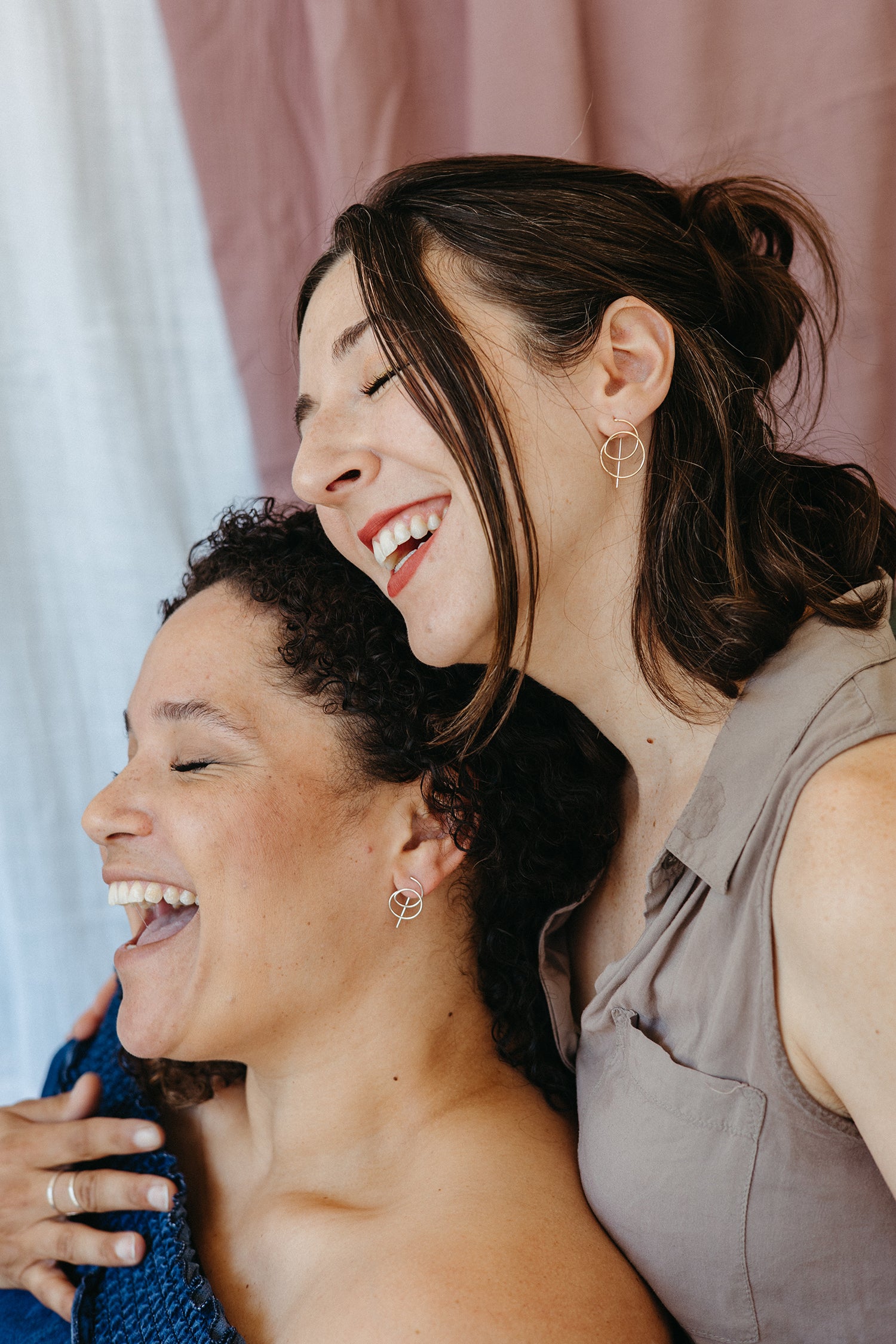 Models wearing petit and tall gold spiral threader hoops