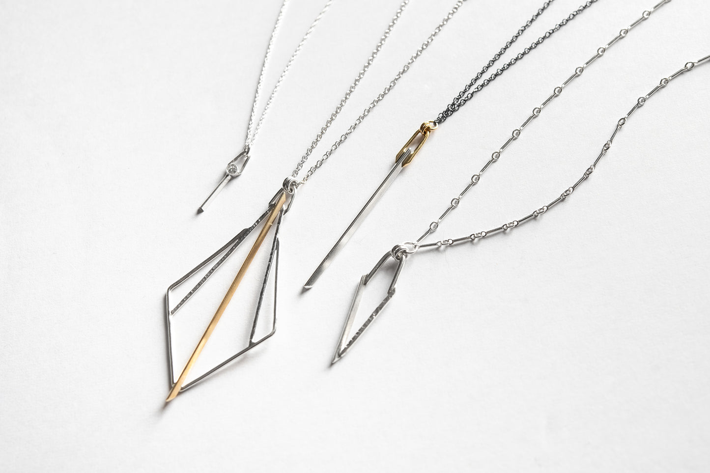 silver and gold knife-edge necklace collection