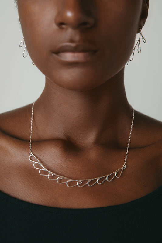 model wearing silver floral collar necklace