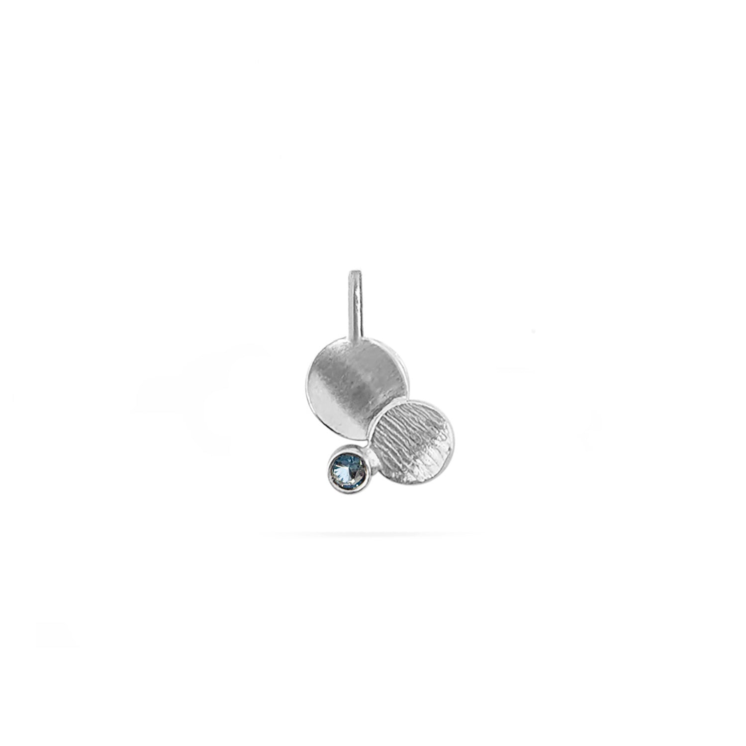 textured concave disk charm with a blue sapphire