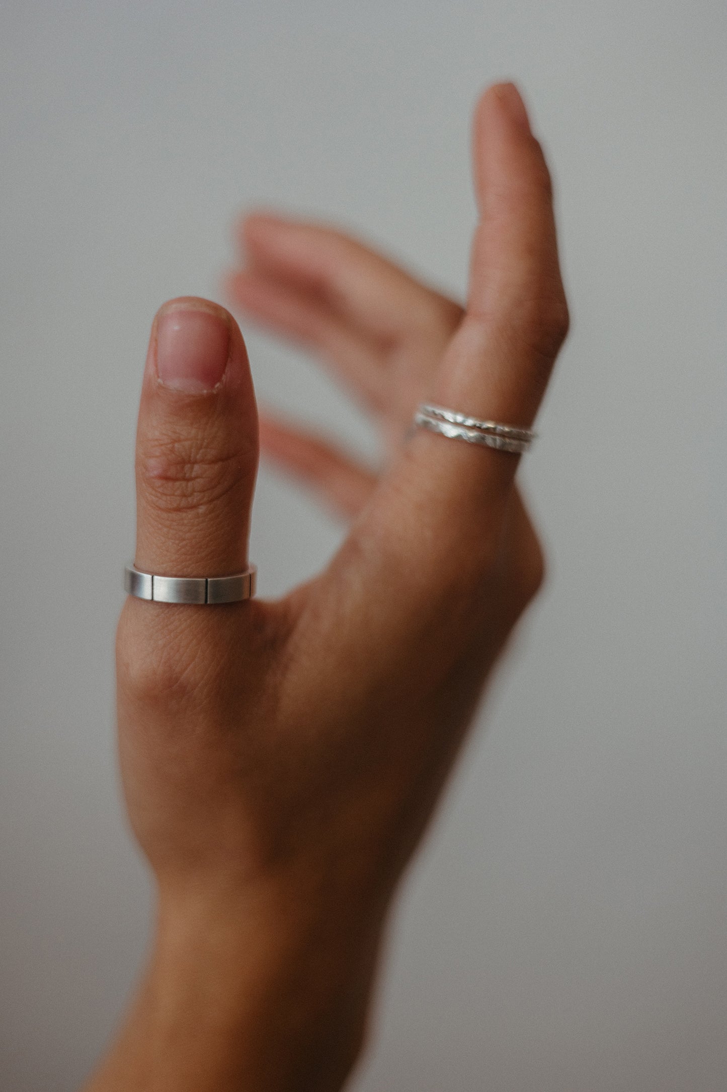 lined silver ring on model paired with slim textured rings