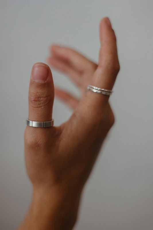 lined silver ring on model paired with slim textured rings