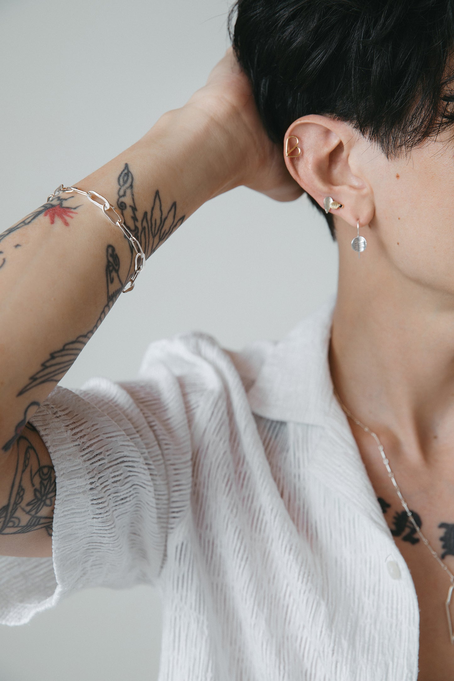 model wearing silver hammered oval link bracelet