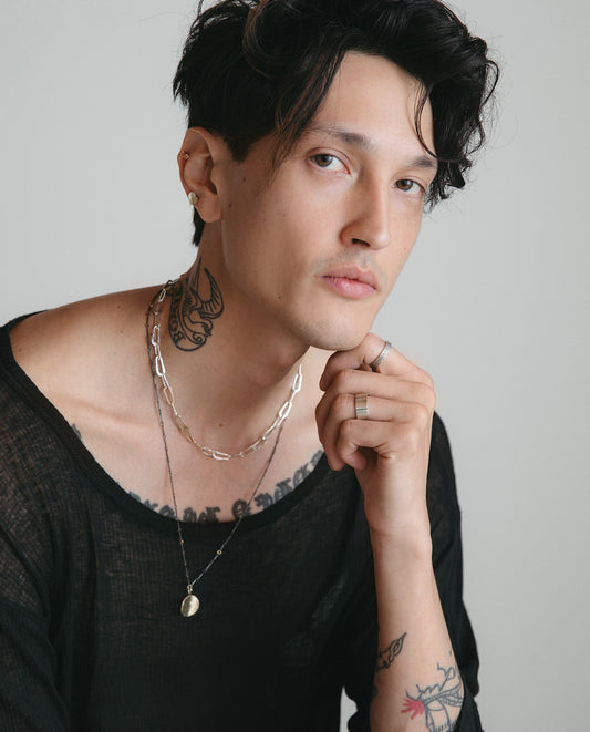 Model wearing silver hammered oval chain link necklace