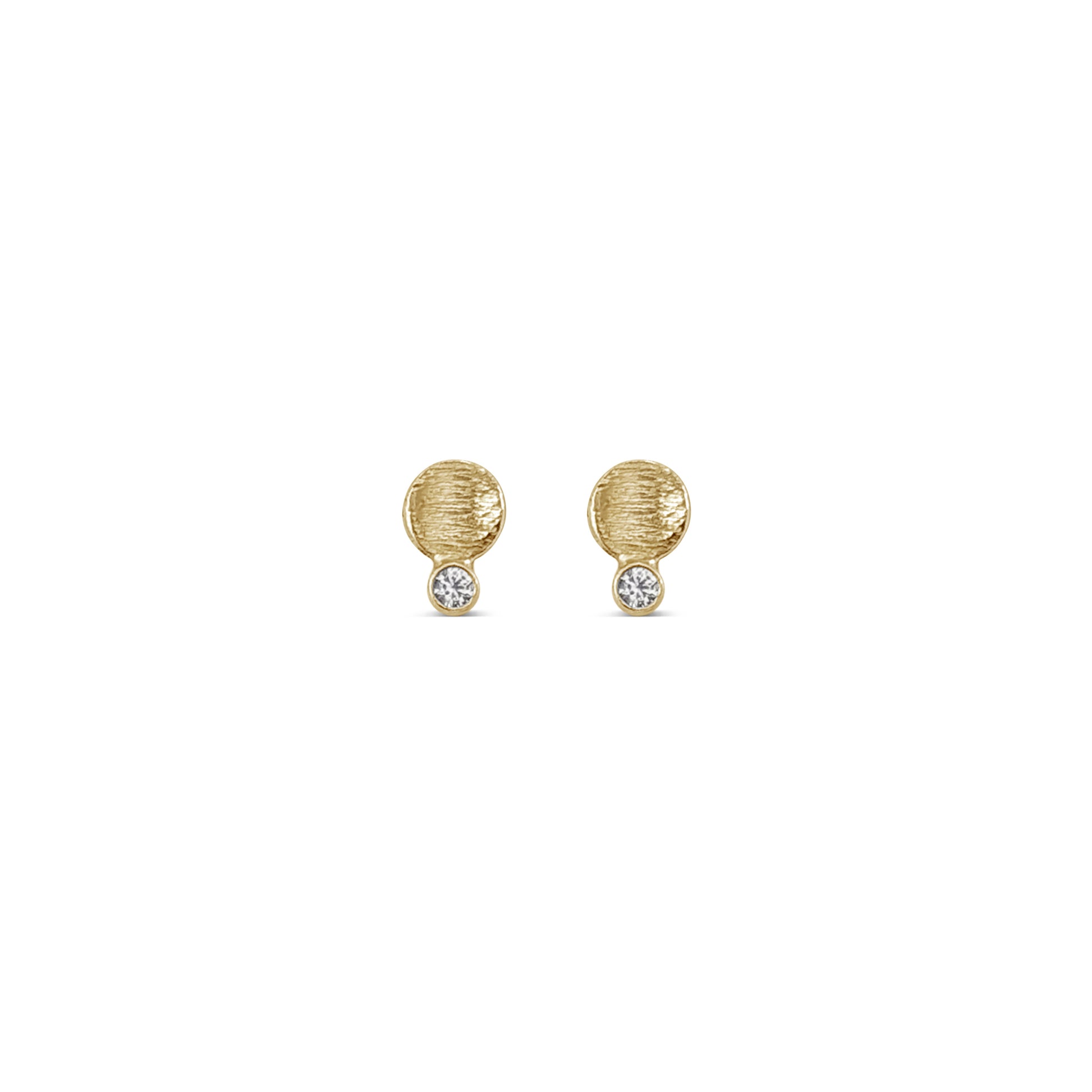 small textured gold disk studs with a diamond connected to the bottom edge
