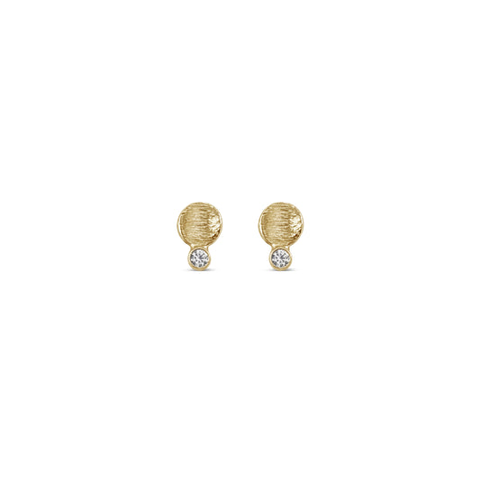 small textured gold disk studs with a diamond connected to the bottom edge