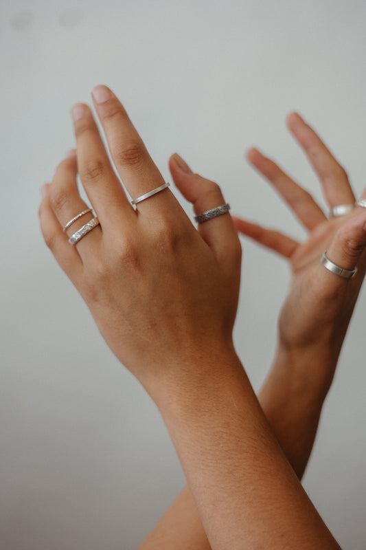 silver textured stacking ring bands on model