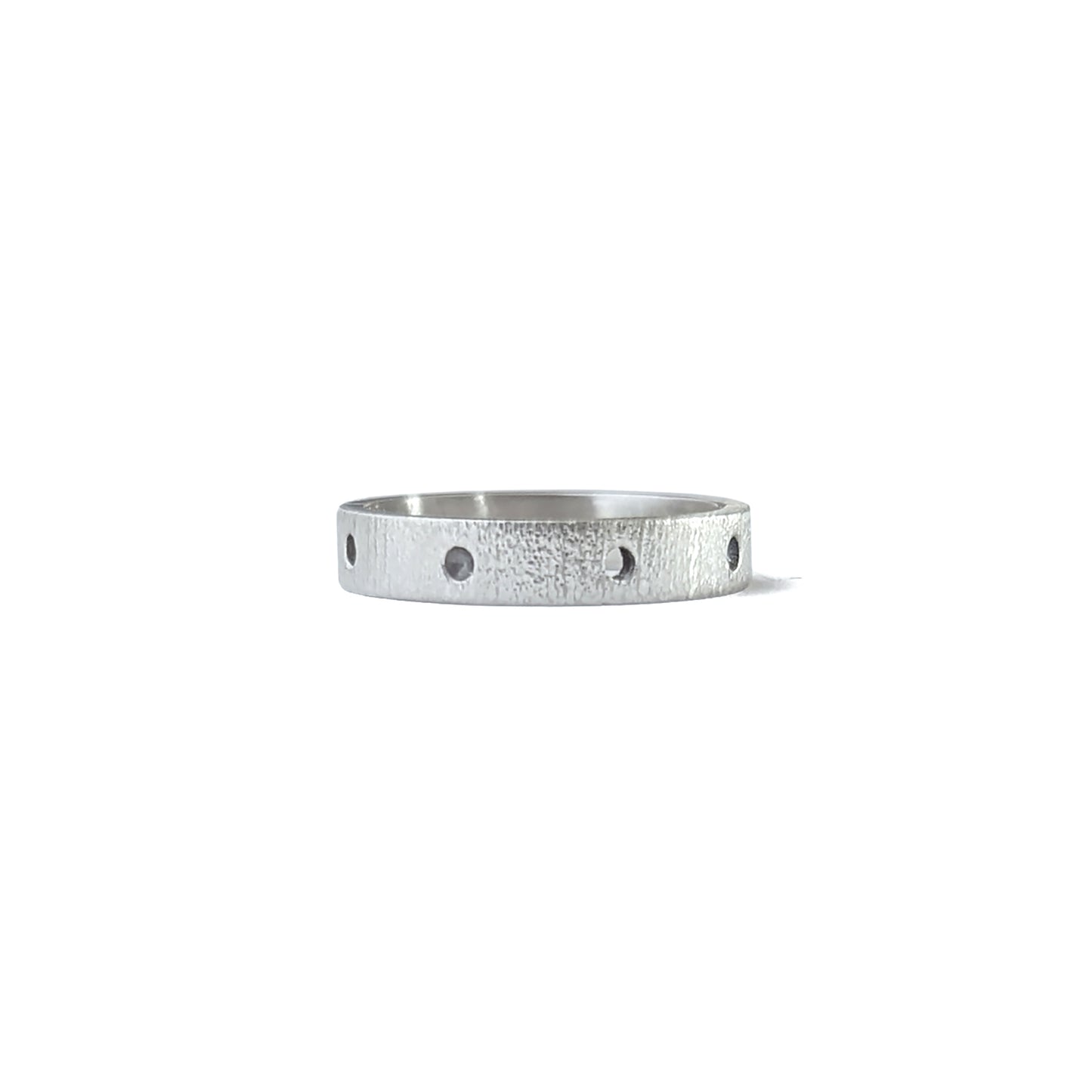 Silver linen textured band lined with circular divots