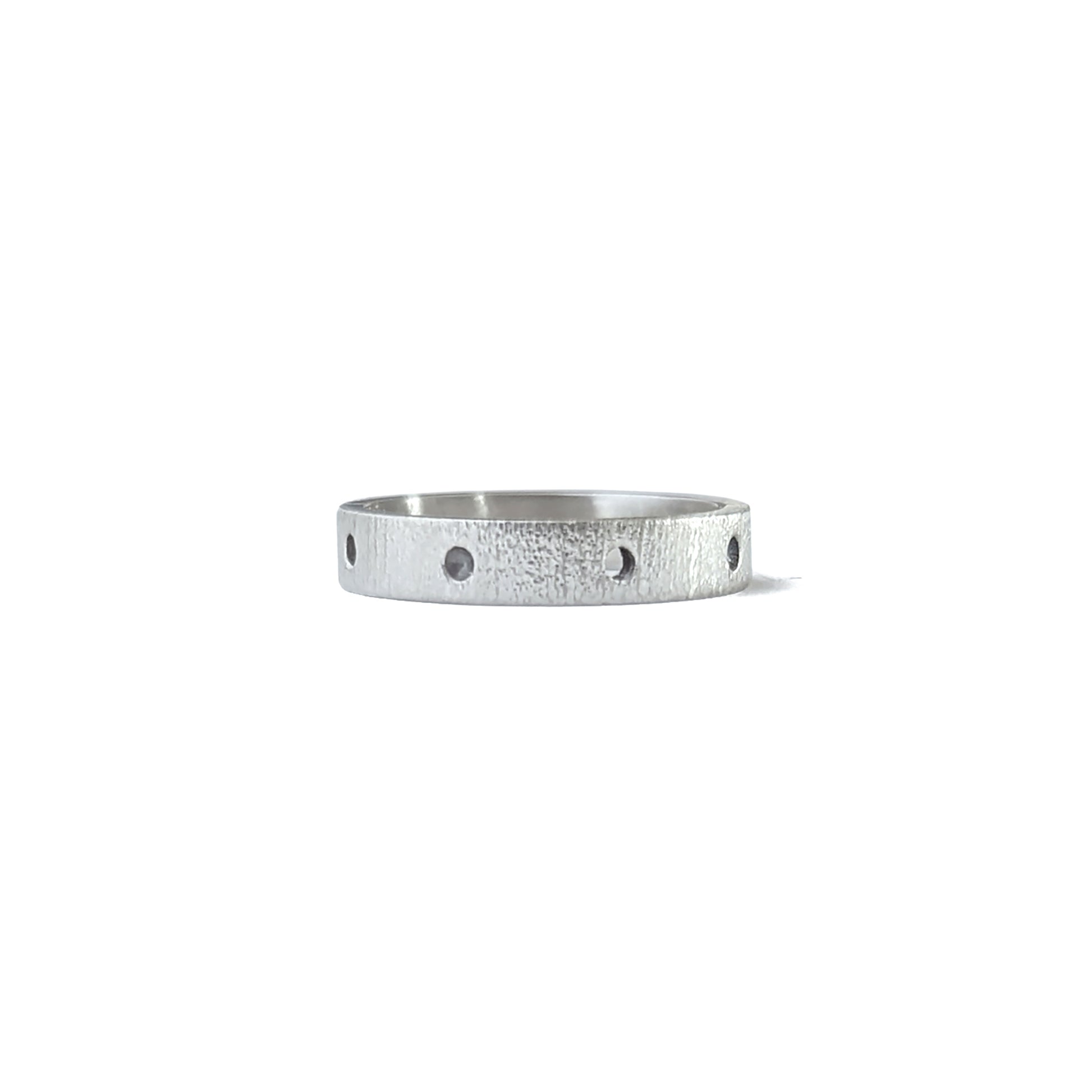 Silver linen textured band lined with circular divots