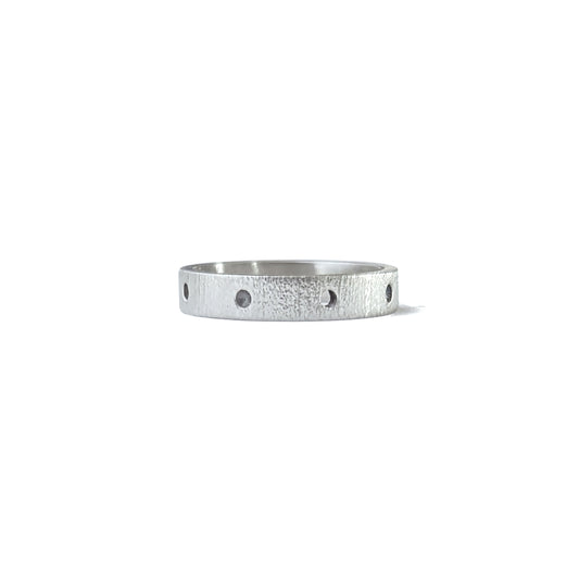 Silver linen textured band lined with circular divots