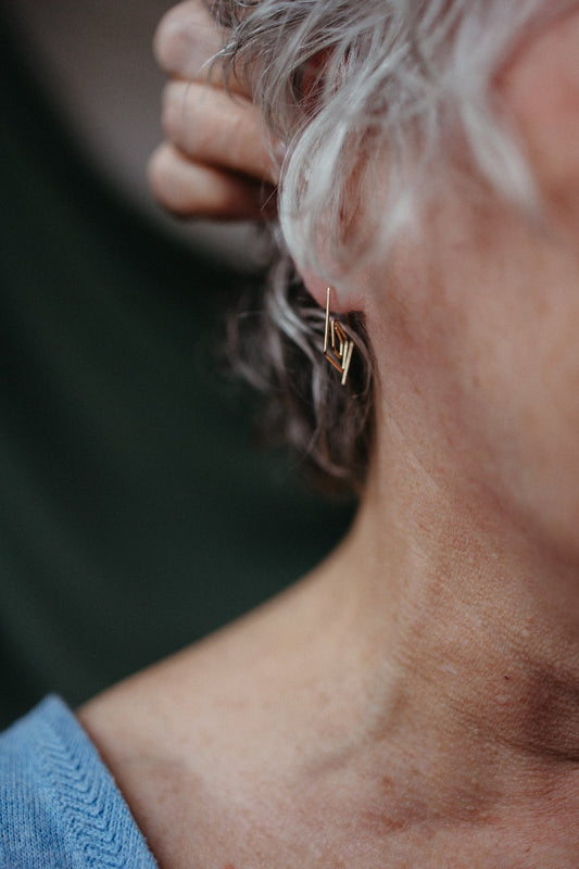 model wearing spiral diamond hoop earrings