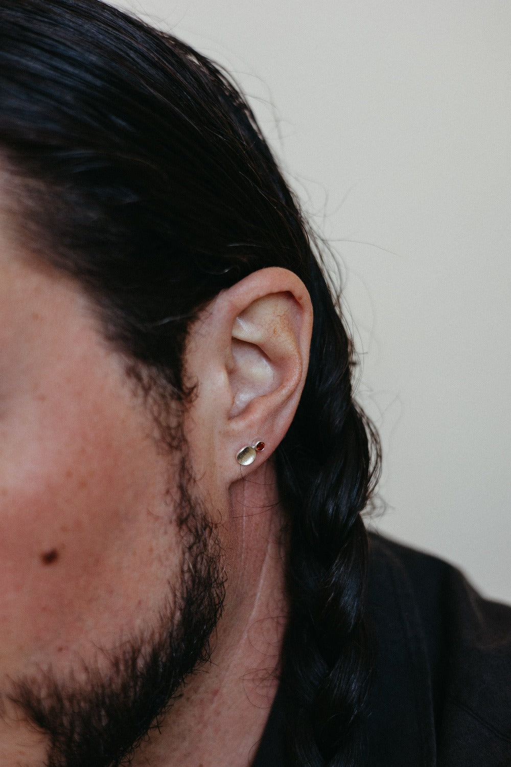 Small silver textured disk studs styled on model