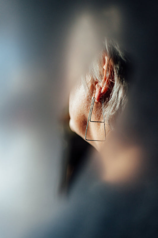 Trapezoid hoop earrings double stacked and styled on model