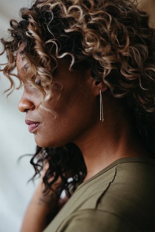 Everyday fine gold hammered trapezoid hoops on model