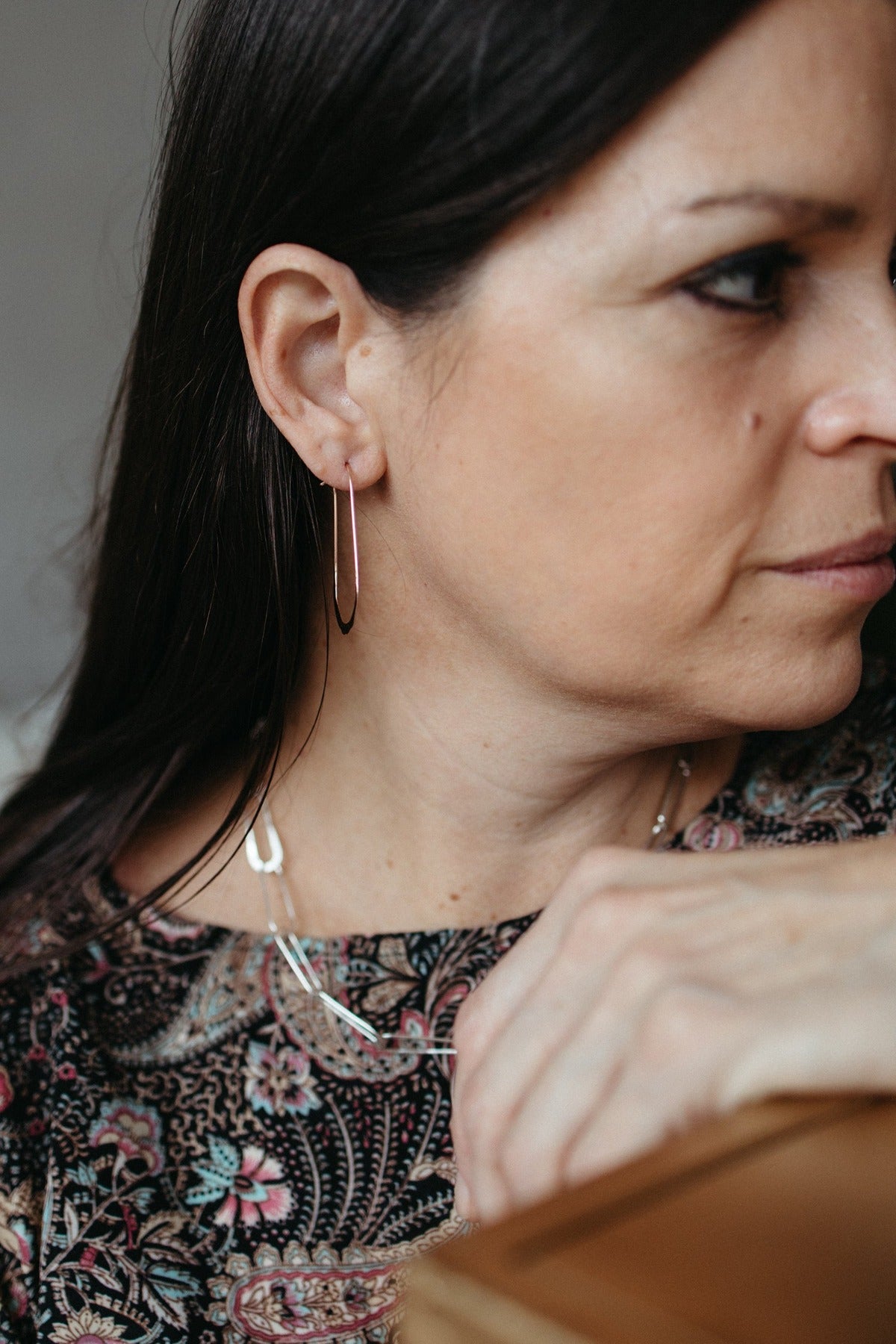 14K rose gold hammered oval hoop earrings styled on model