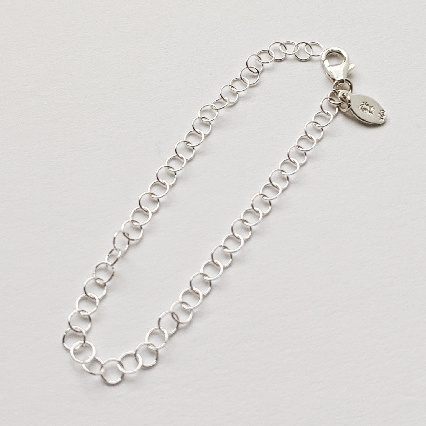 Round silver cable chain extender with clasp and charm