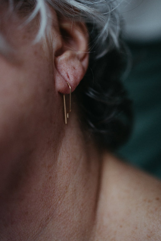 model wearing geometric micro hoop earrings