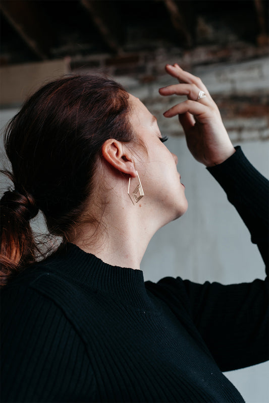 Long diamond spiraled pull-through hoops styled on model
