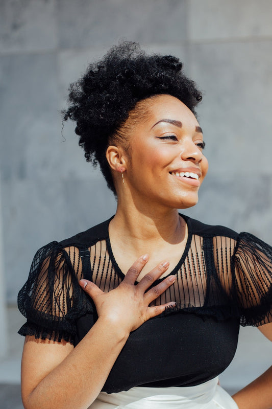 Gold zigzag pull-through hoops on model