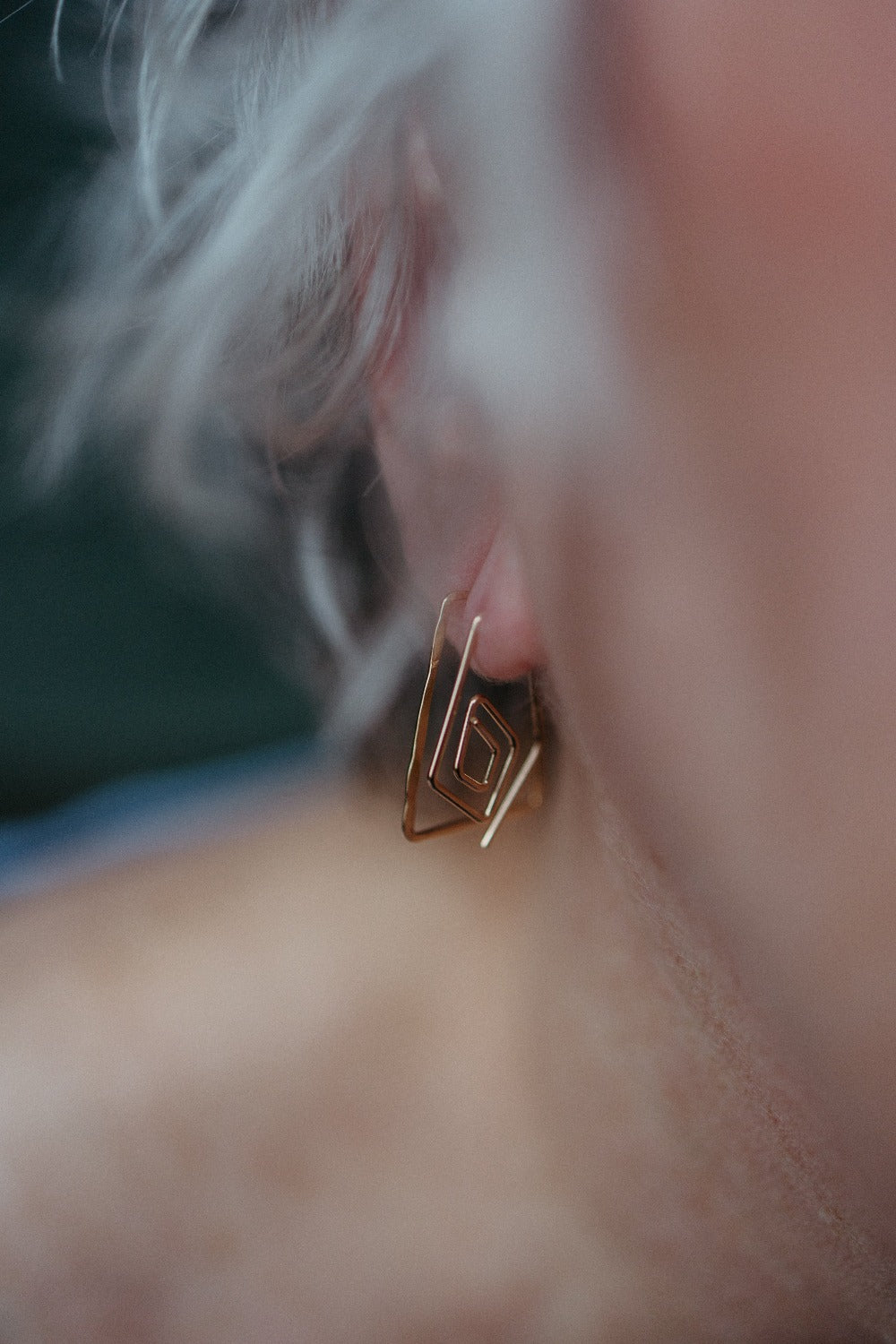 dainty spiral diamond earrings worn by model