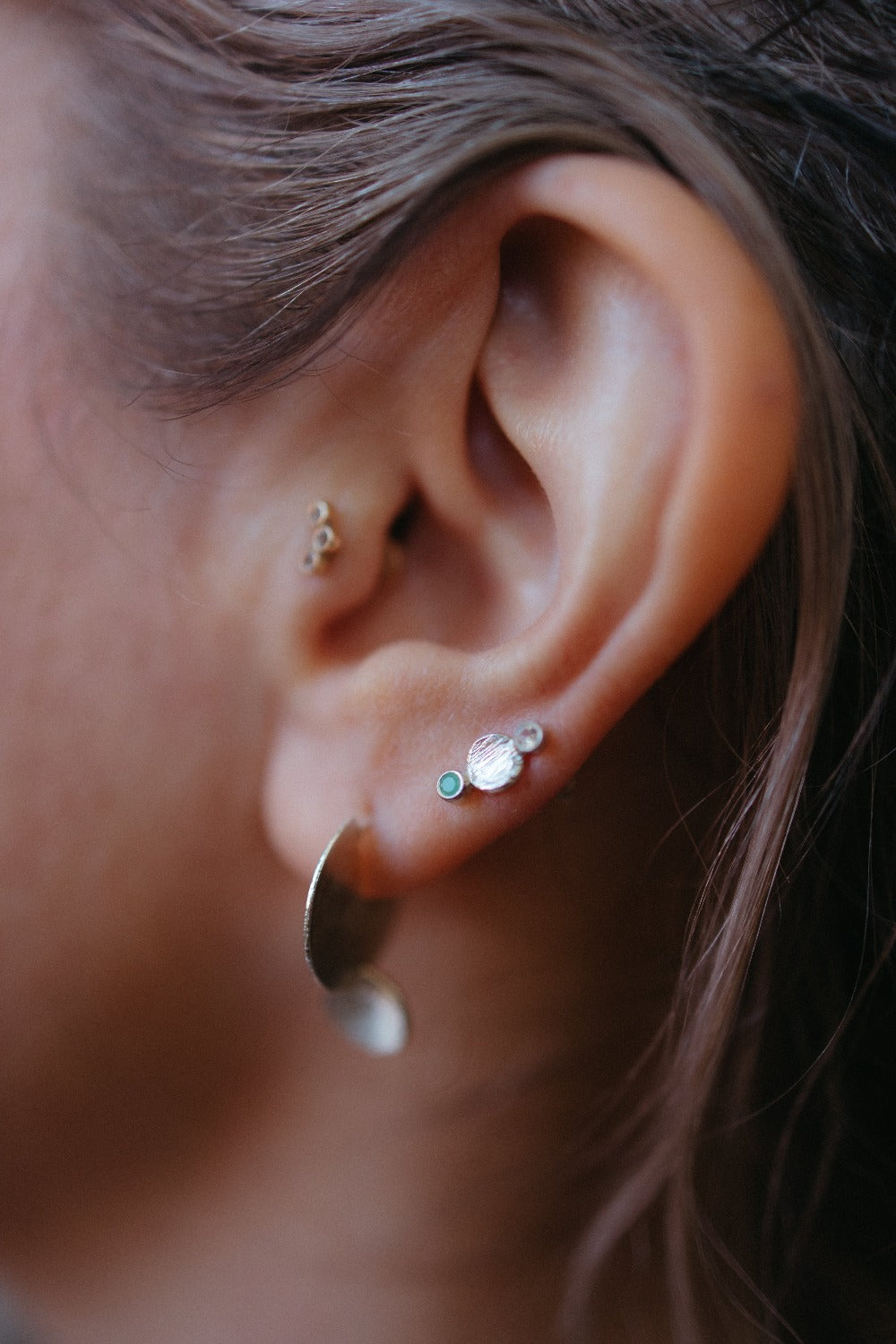 Earring stack with silver drop disk stud earring styled on model