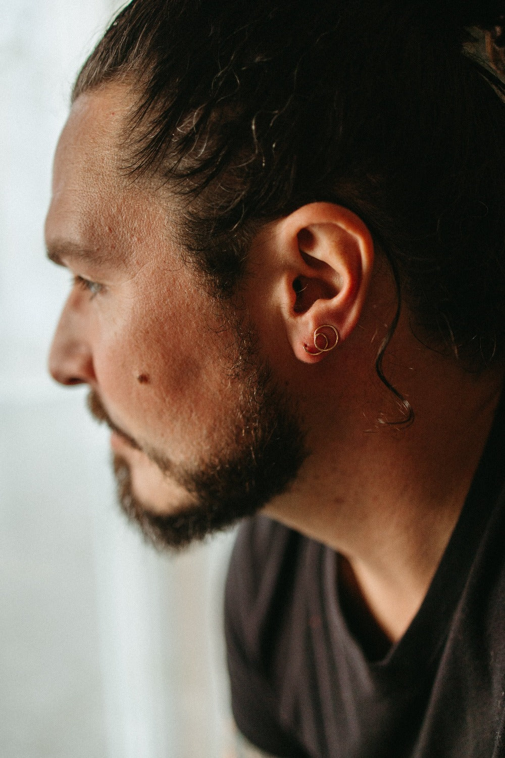 delicate 14K gold round spiral hoops as an ear climber