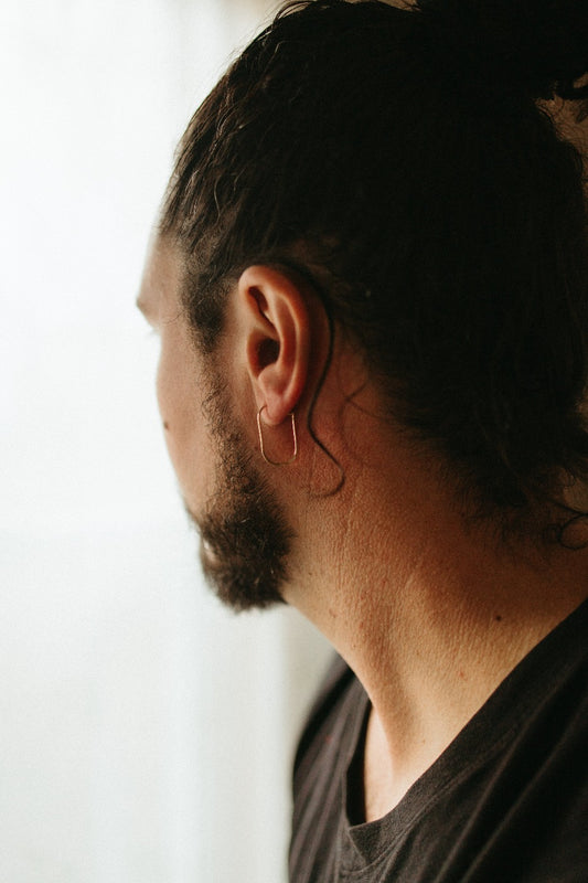 model wearing micro oval hoop earrings