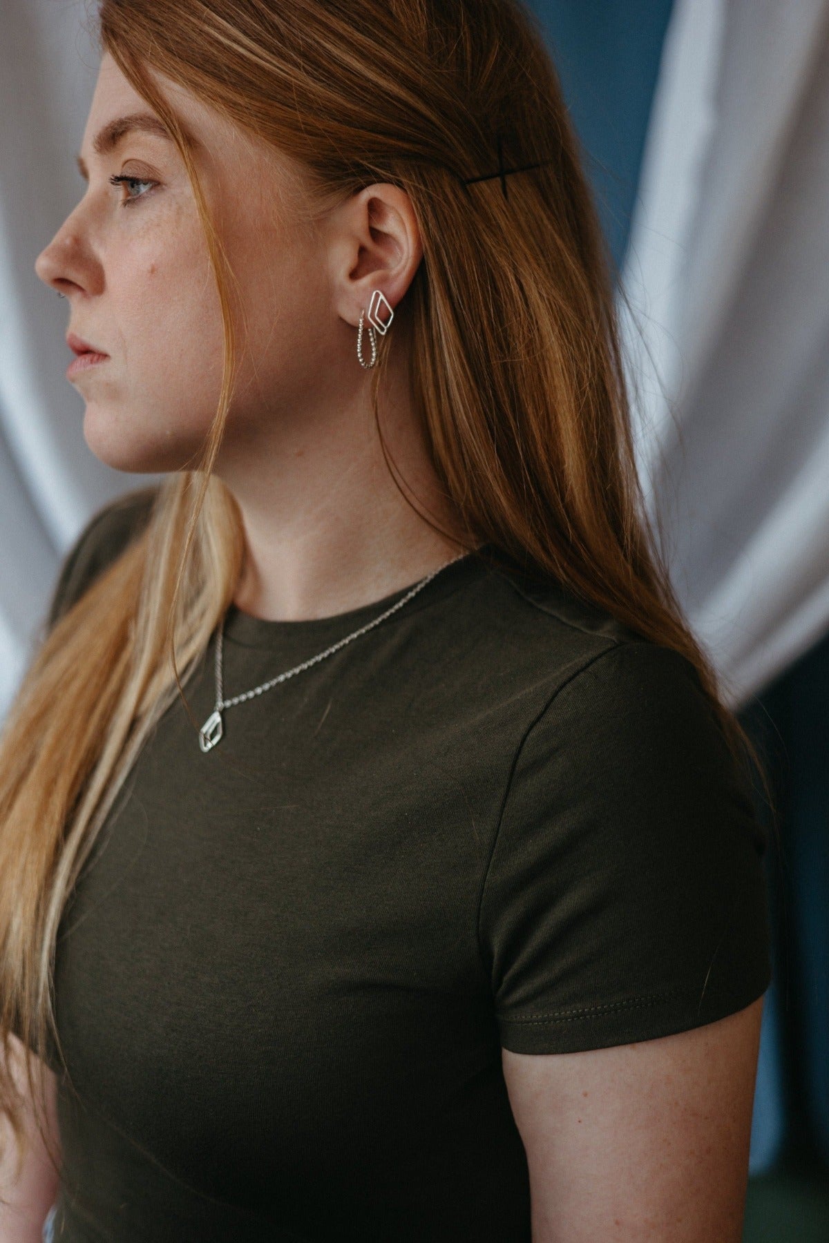 Open diamond-shaped necklace in silver styled on model