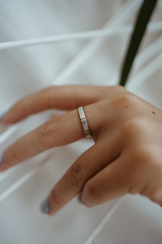 model wearing Silver and black stackable midi line ring